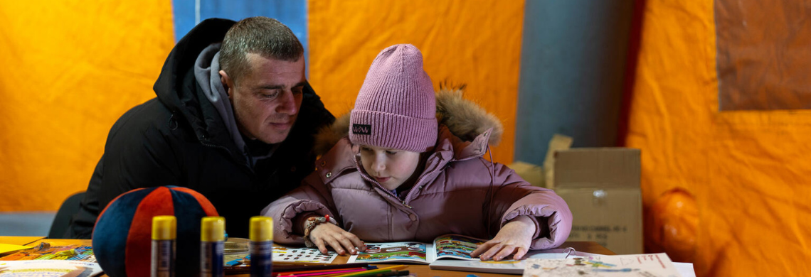 Vater und Tochter beim Spielen in einem Zelt